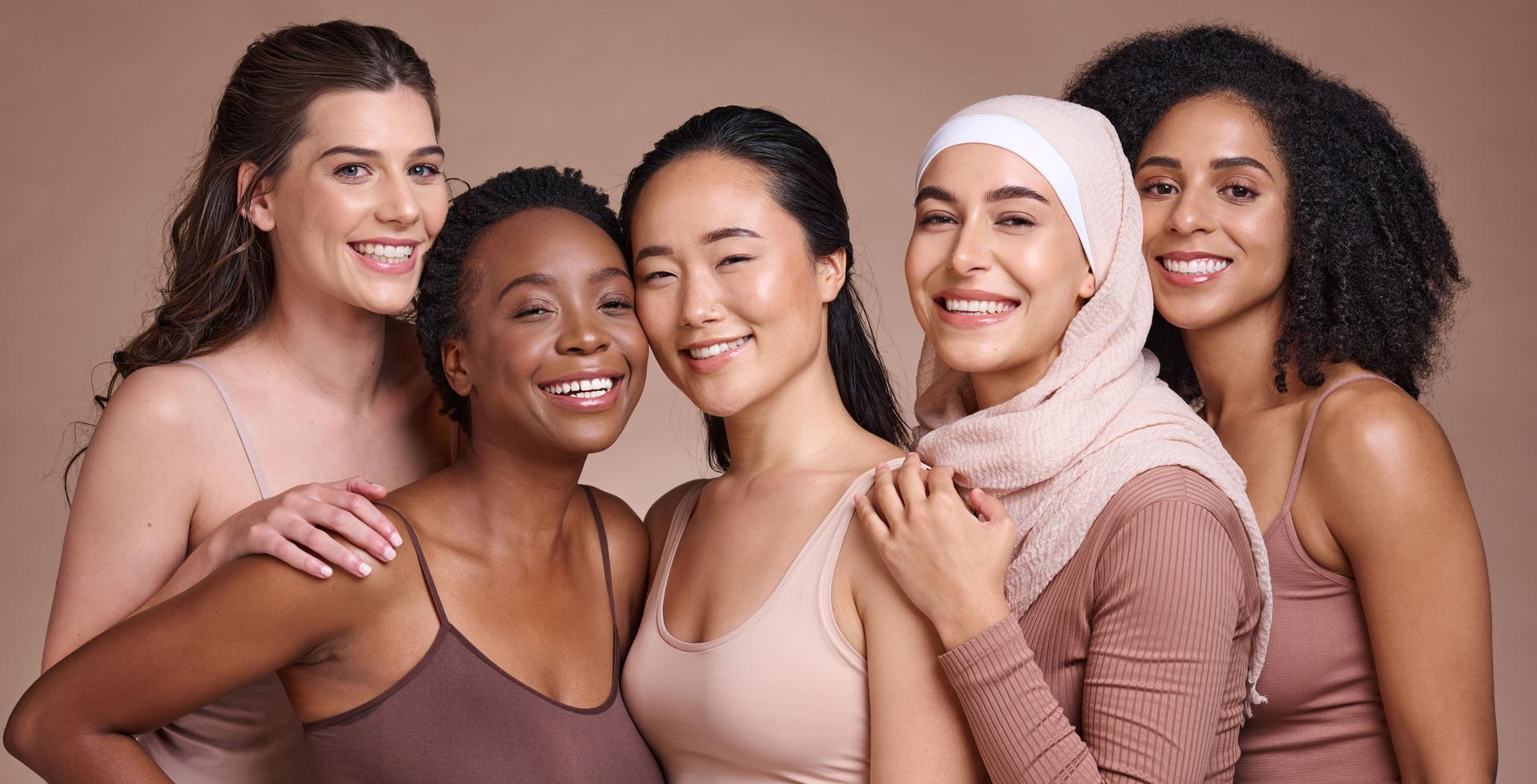 Diversity, women and beauty with skincare and portrait, smile and happy models, different and empowerment with motivation against studio background. Inclusion, equal and gender with culture and skin.